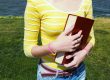 girl reading a book at the outdoors